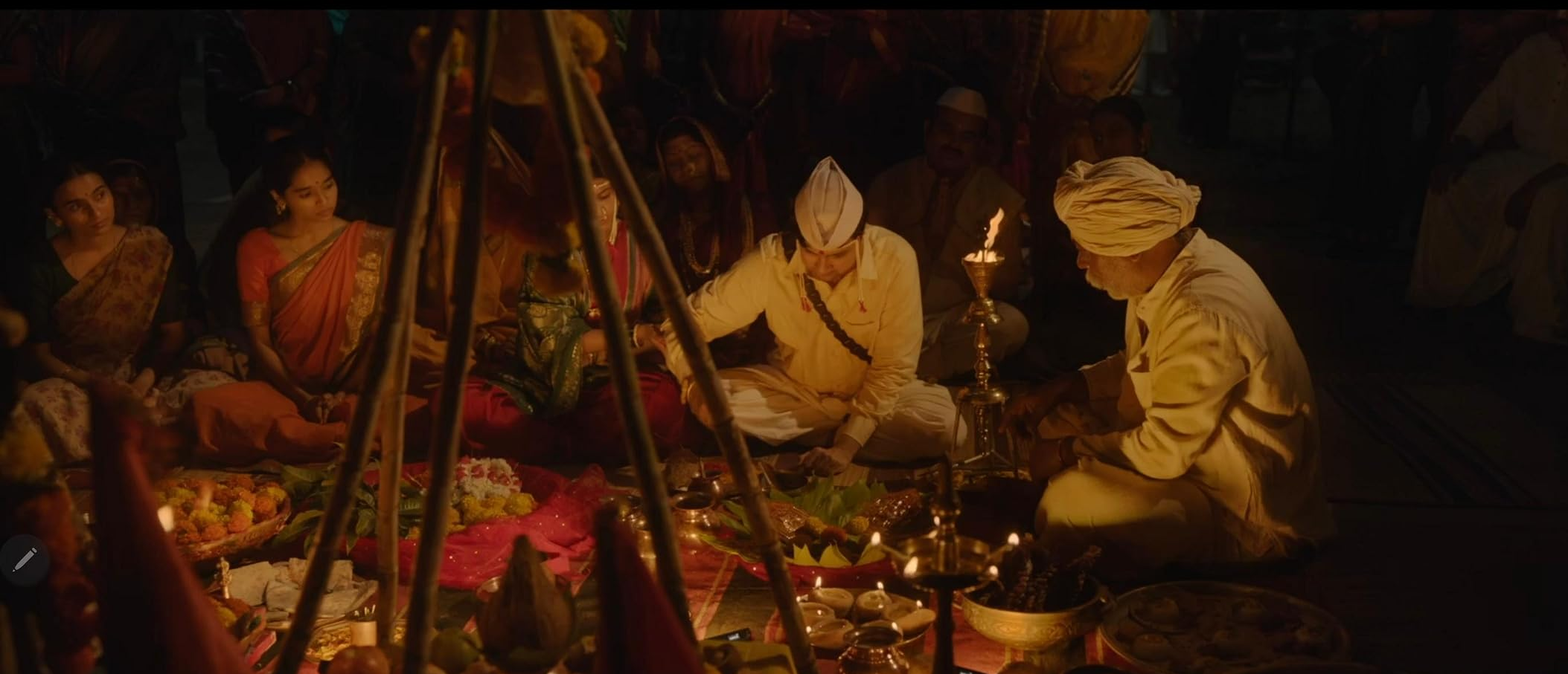 Cinematic trailer still from the Marathi film Gondhal featuring a traditional masked folk performer during an all-night village ritual